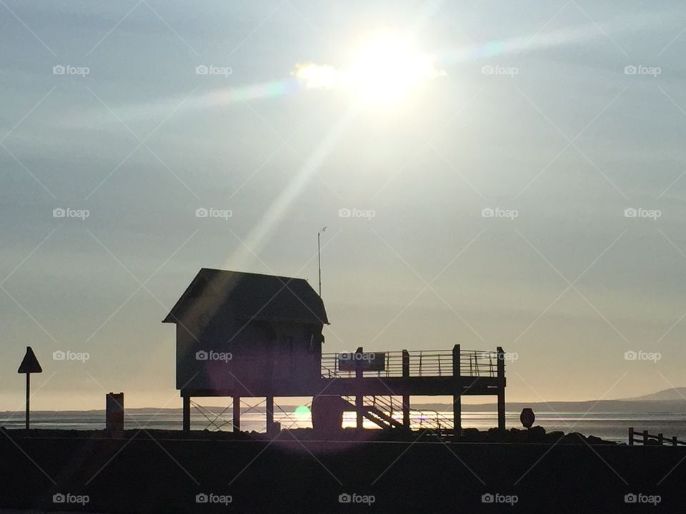 John Smalley . Morcambe sea front. Sailing club house with sunset 