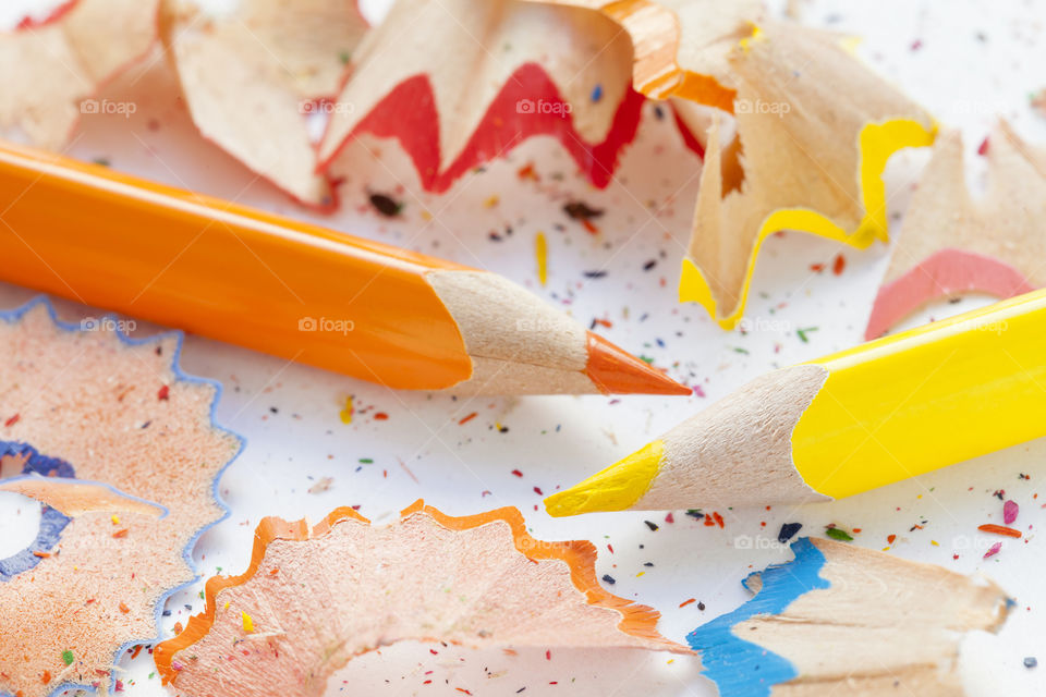 Close-up of colored pencils with shavings