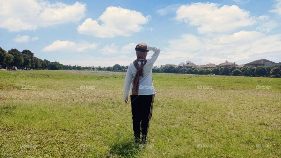 woman standing in field against sky