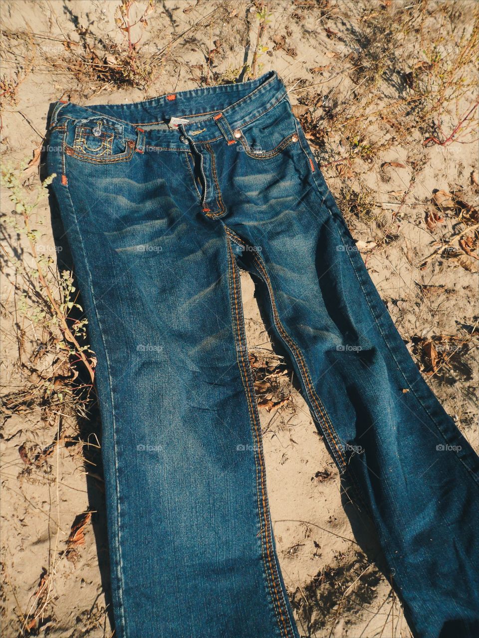 Jeans lie on the sand