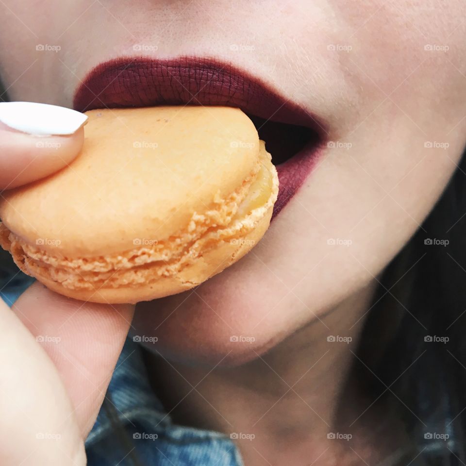 Woman eating macaroons