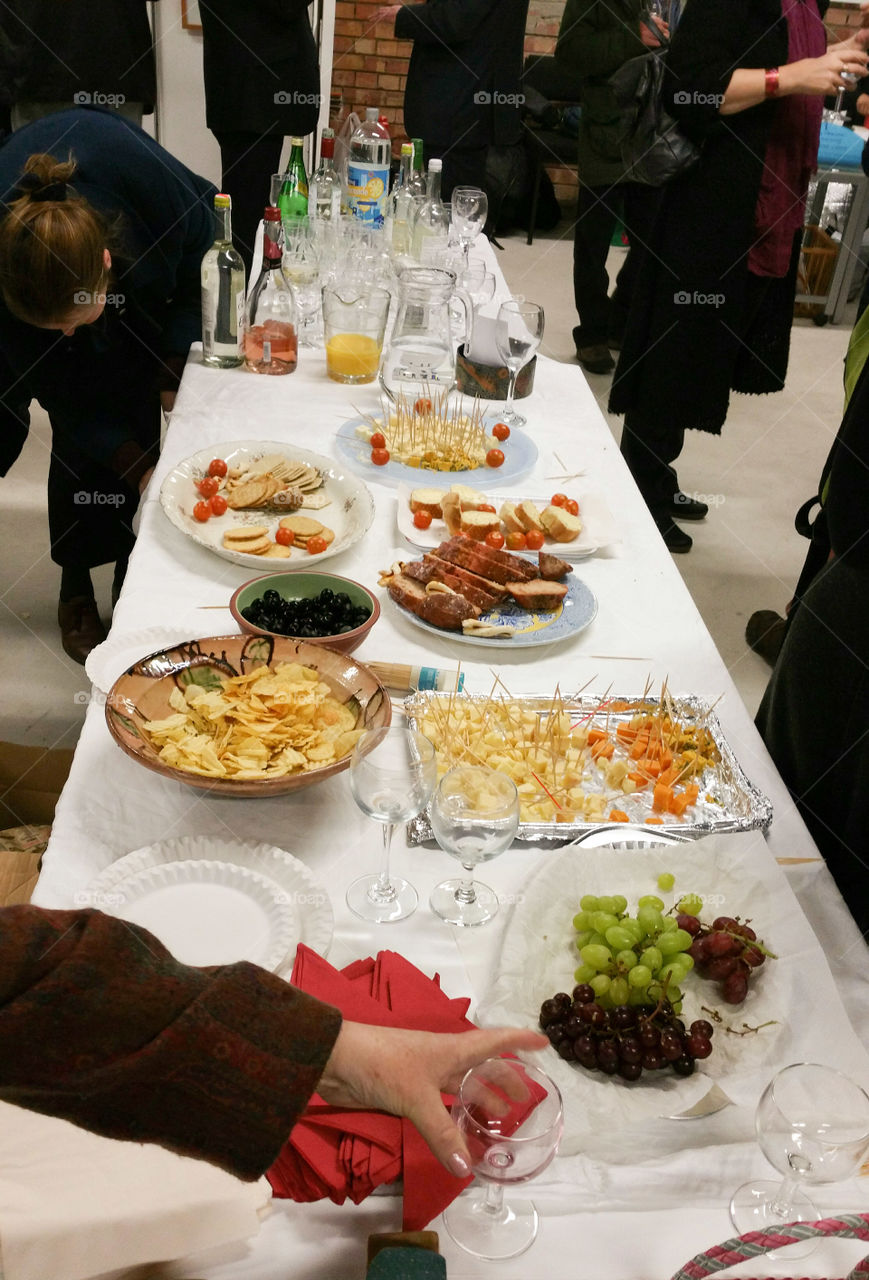 Snacks and drinks table at an art gallery exhibition opening