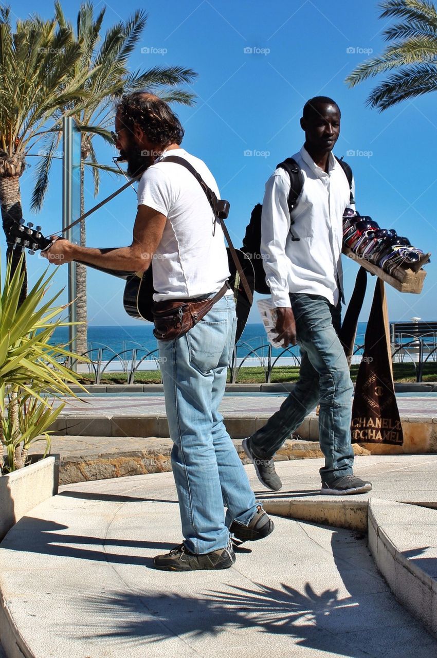 A trubadur and a salesman at the boardwalk