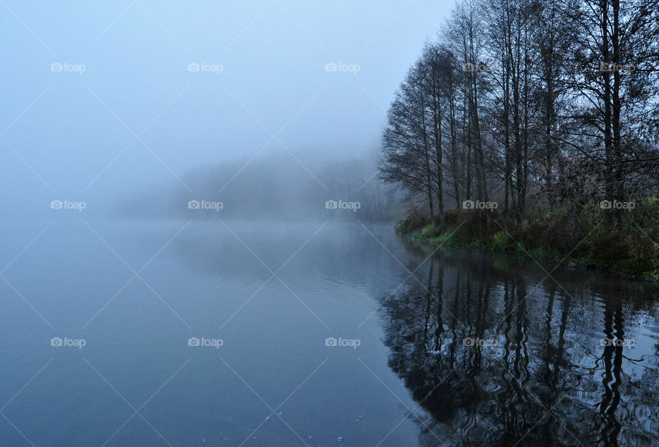 Sea against foggy sky