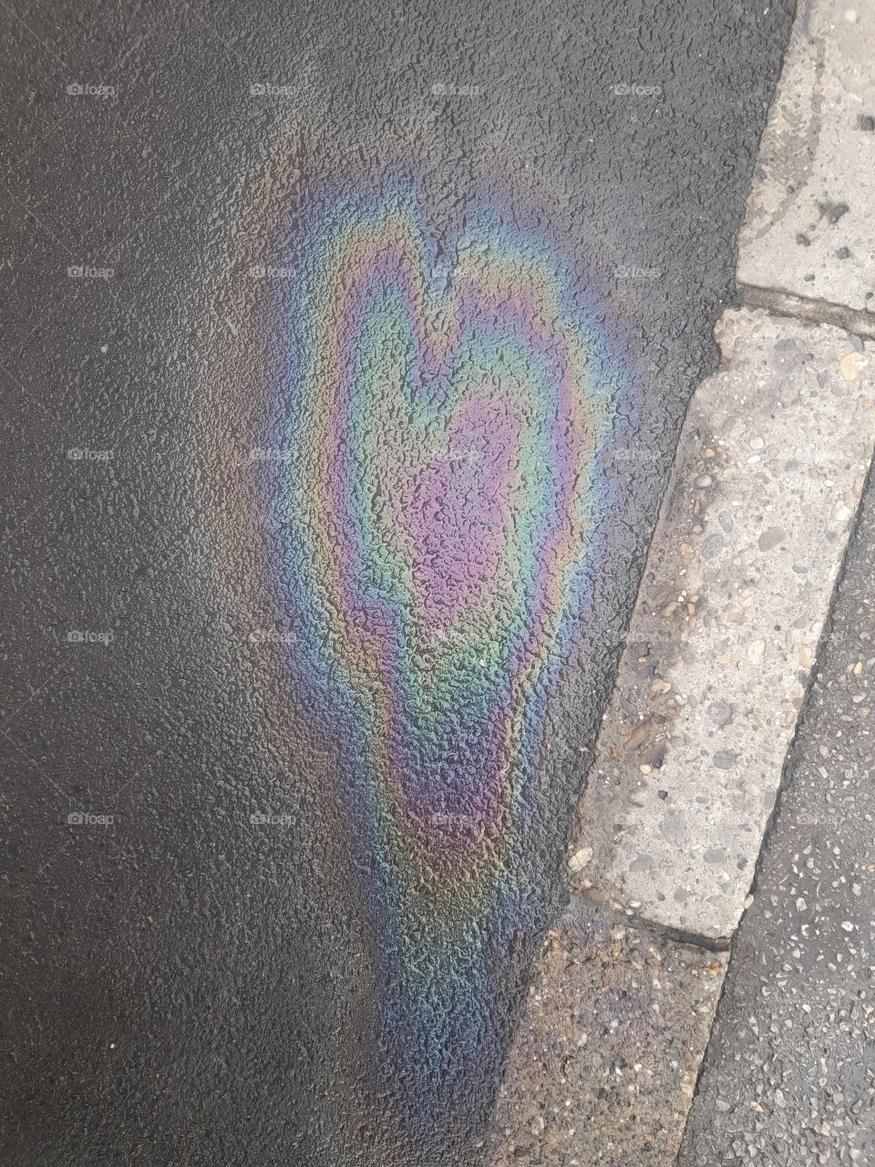heart from gasoline on sidewalk