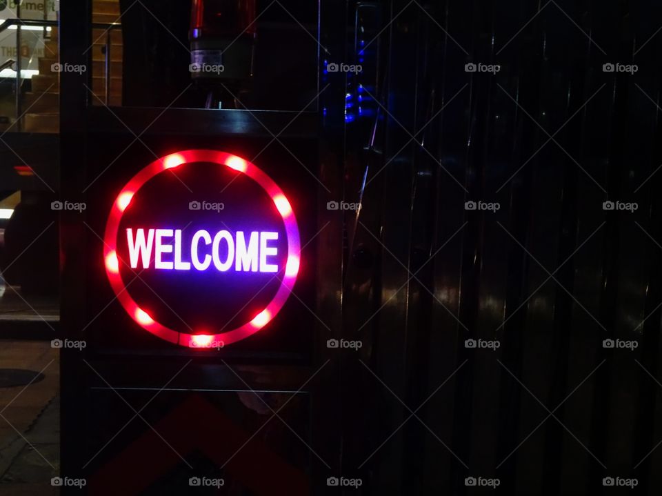 welcome written in neon lights