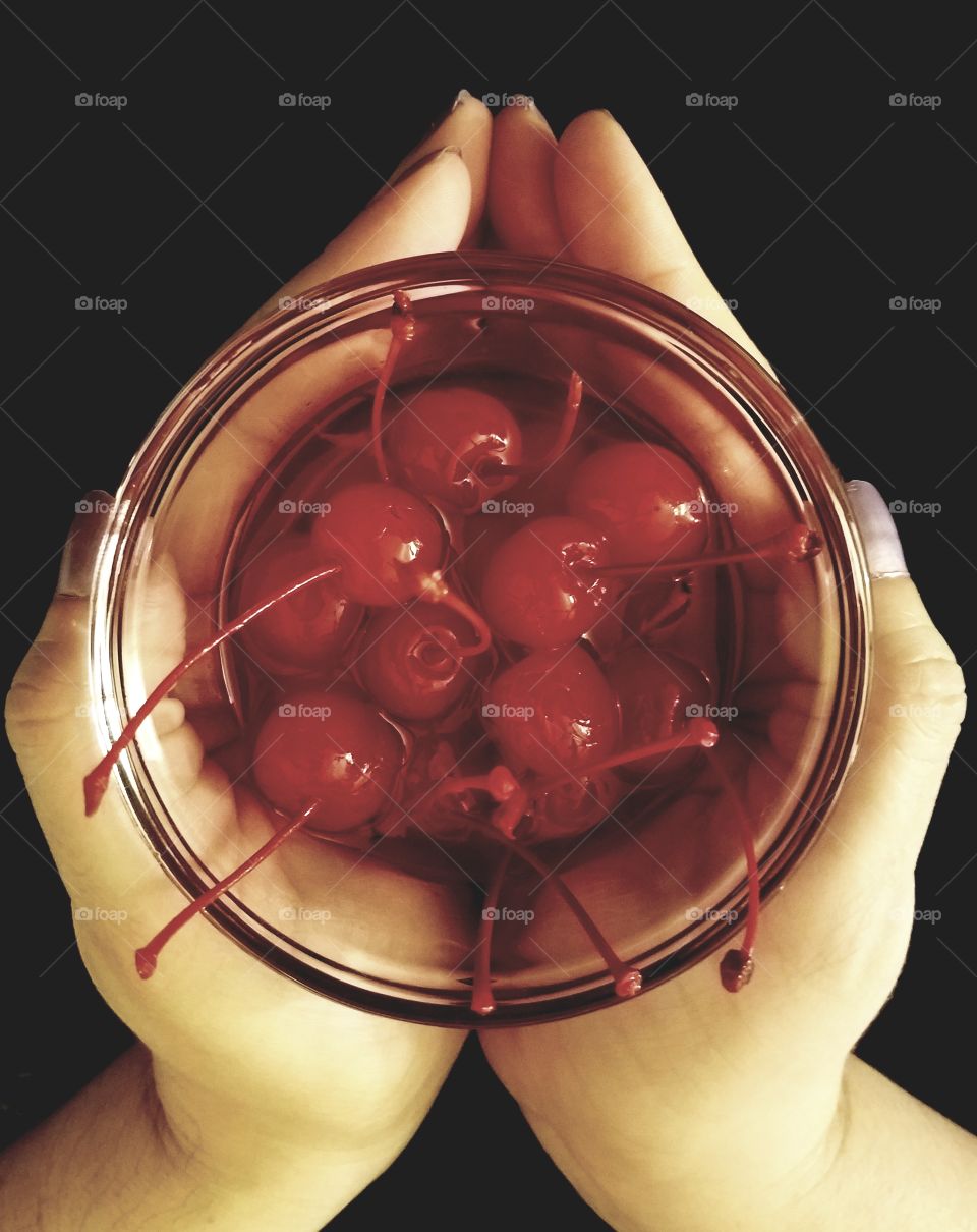 holding food maraschino cherries
