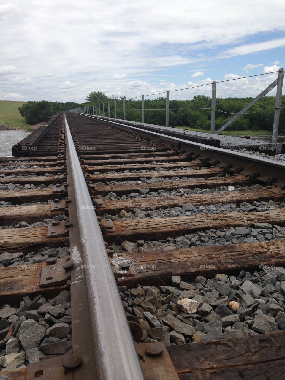 Ride the rails. Railroad tracks over river