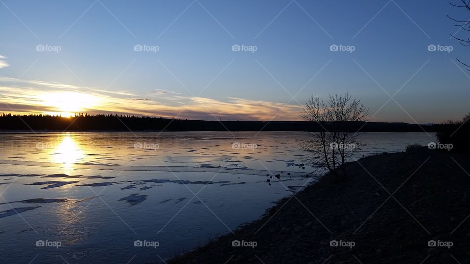 sun setting over a frozen Glenmore Reservoir