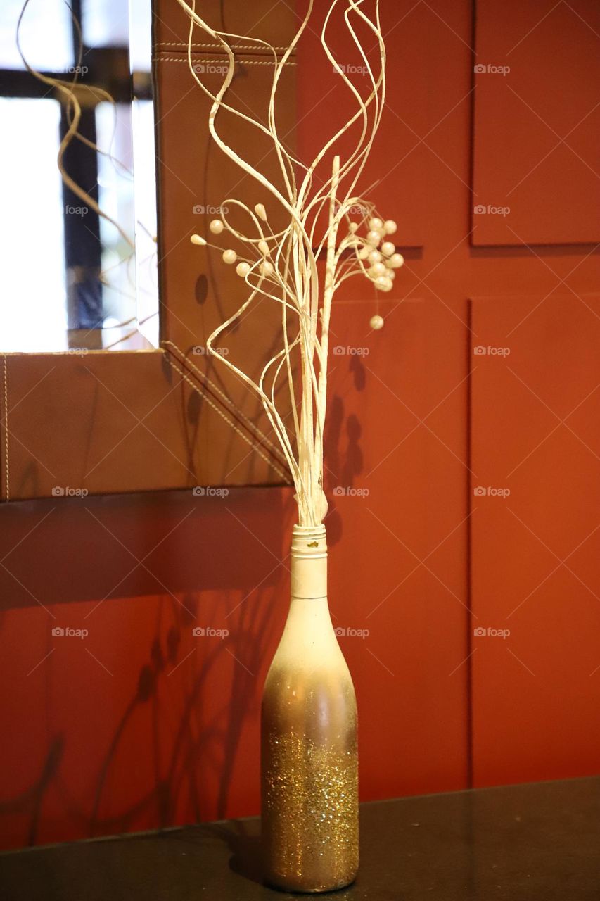 Vase with dry flower by the window 