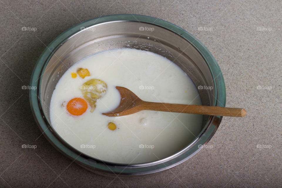 Eggs and milk in the plate, cooking