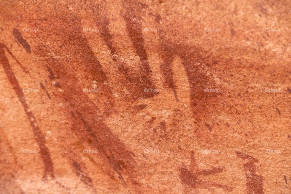 baby hand in adult hand cave painting fuggini cave. wadi sura. gilf kebir. egypt. abstract by ann