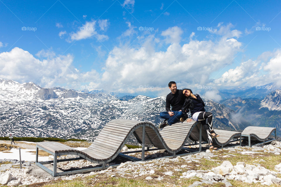 Happy couple sitting on bench