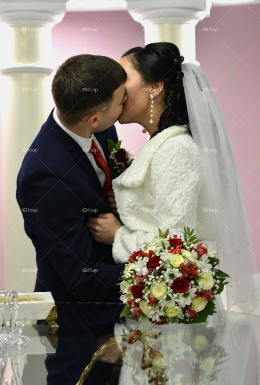 couple kisses wedding ceremony