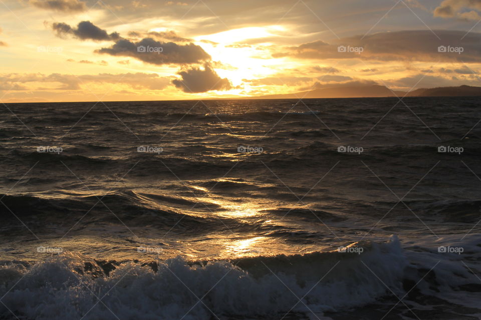 Some sunrise shots of the ocean on a windy Pacific Northwest morning. The high tide created frothy waves breaking on the shore. There were some clouds but the sun shone through creating beautiful colour in the sky and sea.