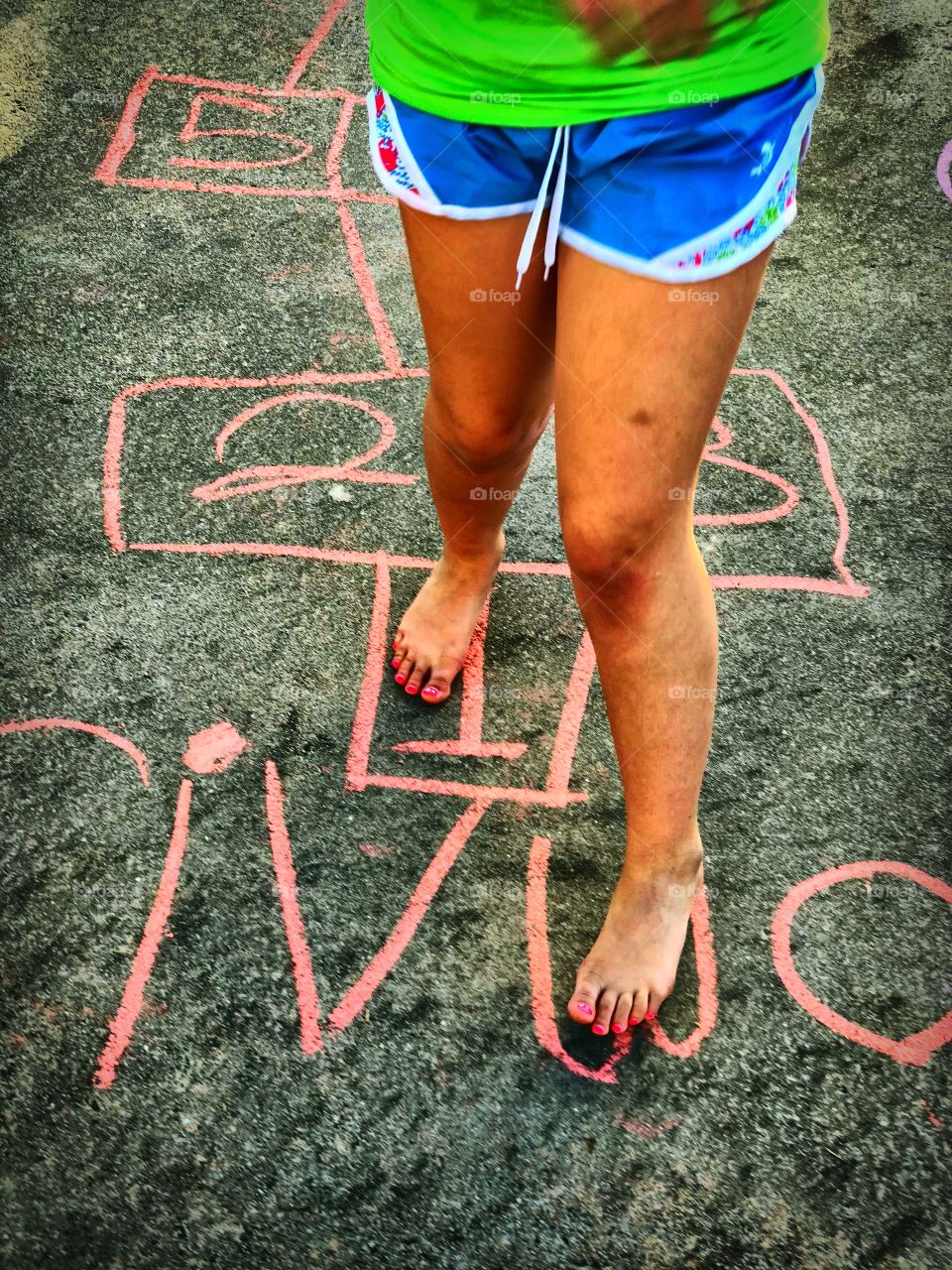 Girl playing hopscotch 