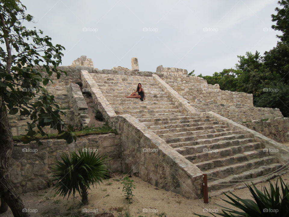 Woman and pyramid steps in Mexico.