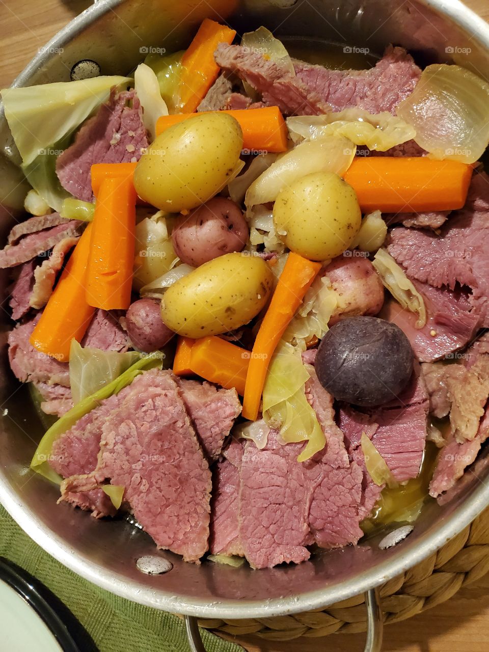 St. Patrick's Day Feast, Juicy sliced Corn Beef and Cabbage with mixed colored potatoes and carrots. One pot meal.