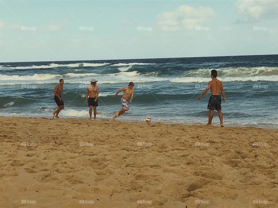 Playing soccer at the beach