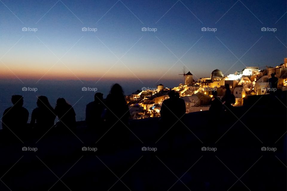 Silhouettes at sunset in Oia, Santorini, Greece 