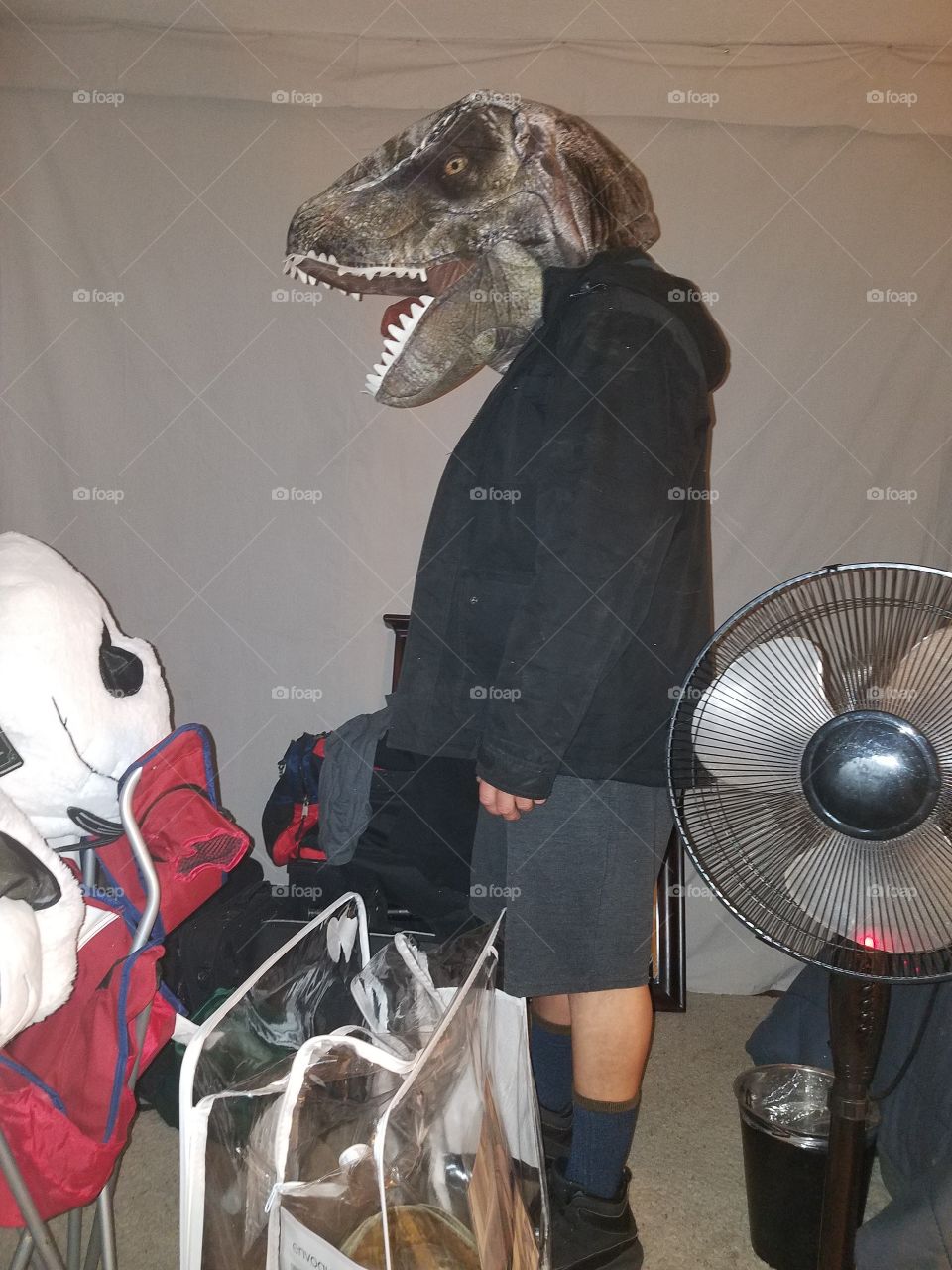 My boyfriend with a Dinosaur head on from the movie Jurassic Park.