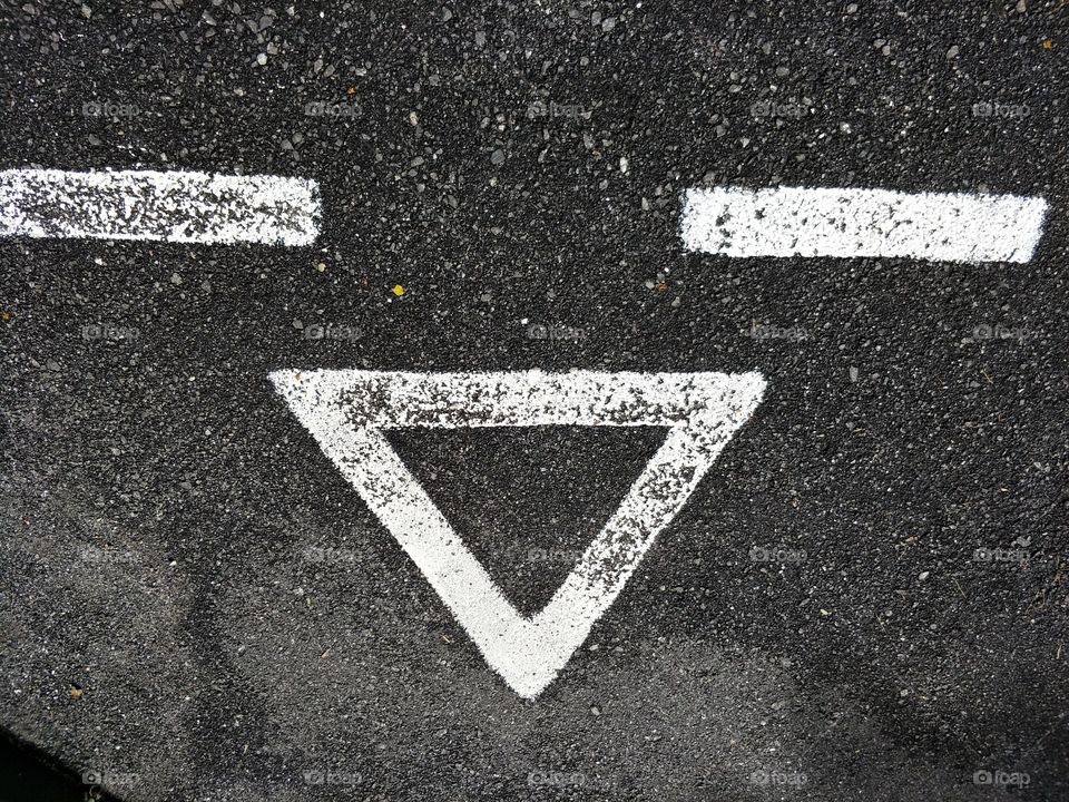 happy face sign on the road