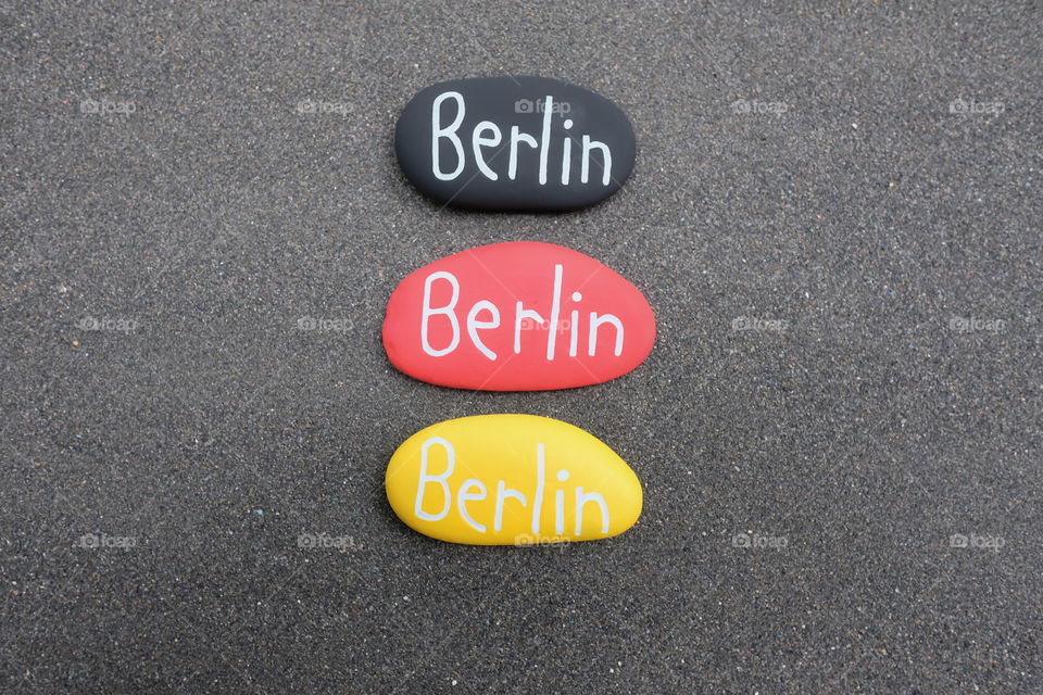 Berlin text on three stones with german flag colors