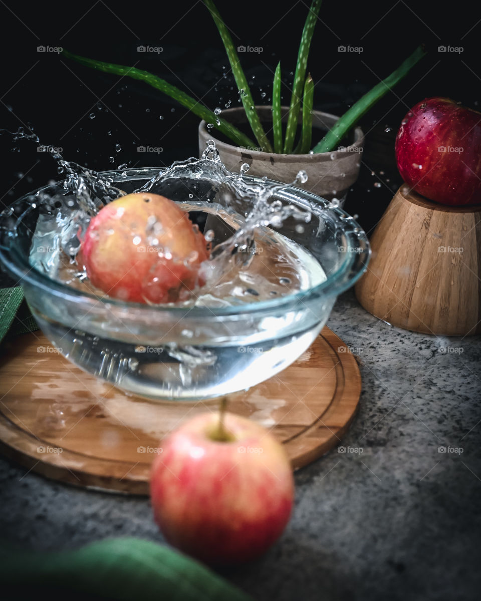 Red apple splash, red apple splash photography, shot in natural light , autumn, autumn season 