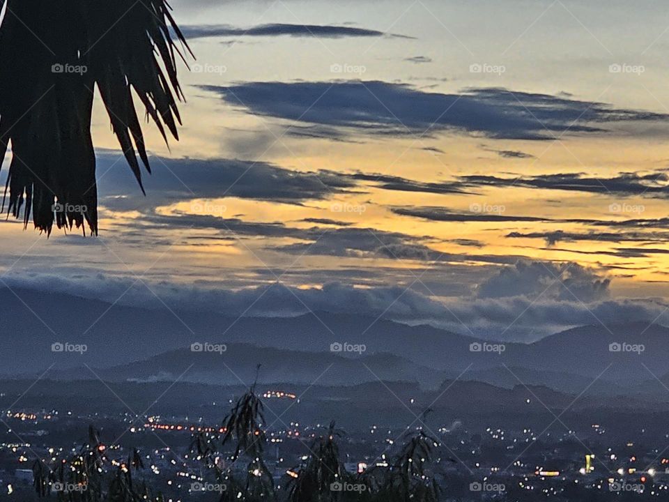 Mountain and city in evening .