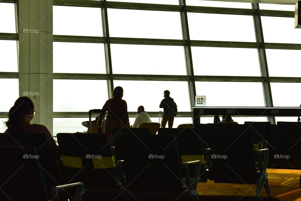 silhouette of passengers at airport  lobby relaxing and waiting