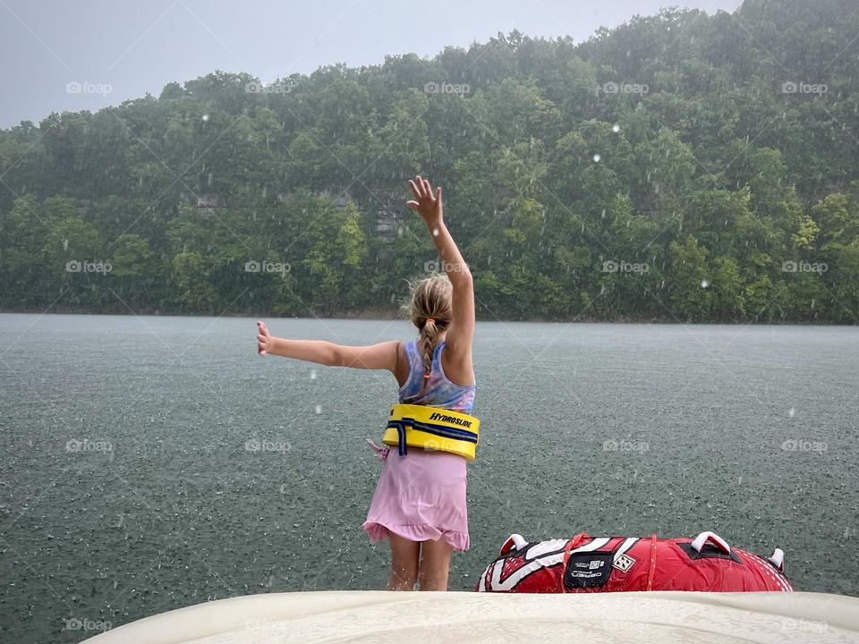 Having fun dancing in the rain on a boat