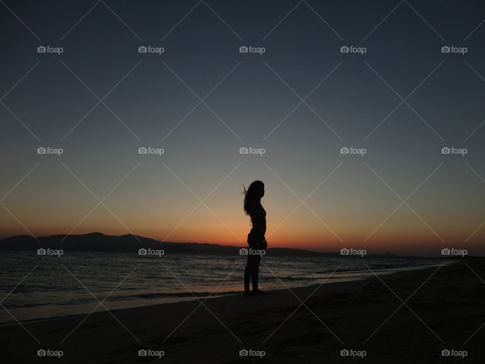 Girl silhouette on the beach