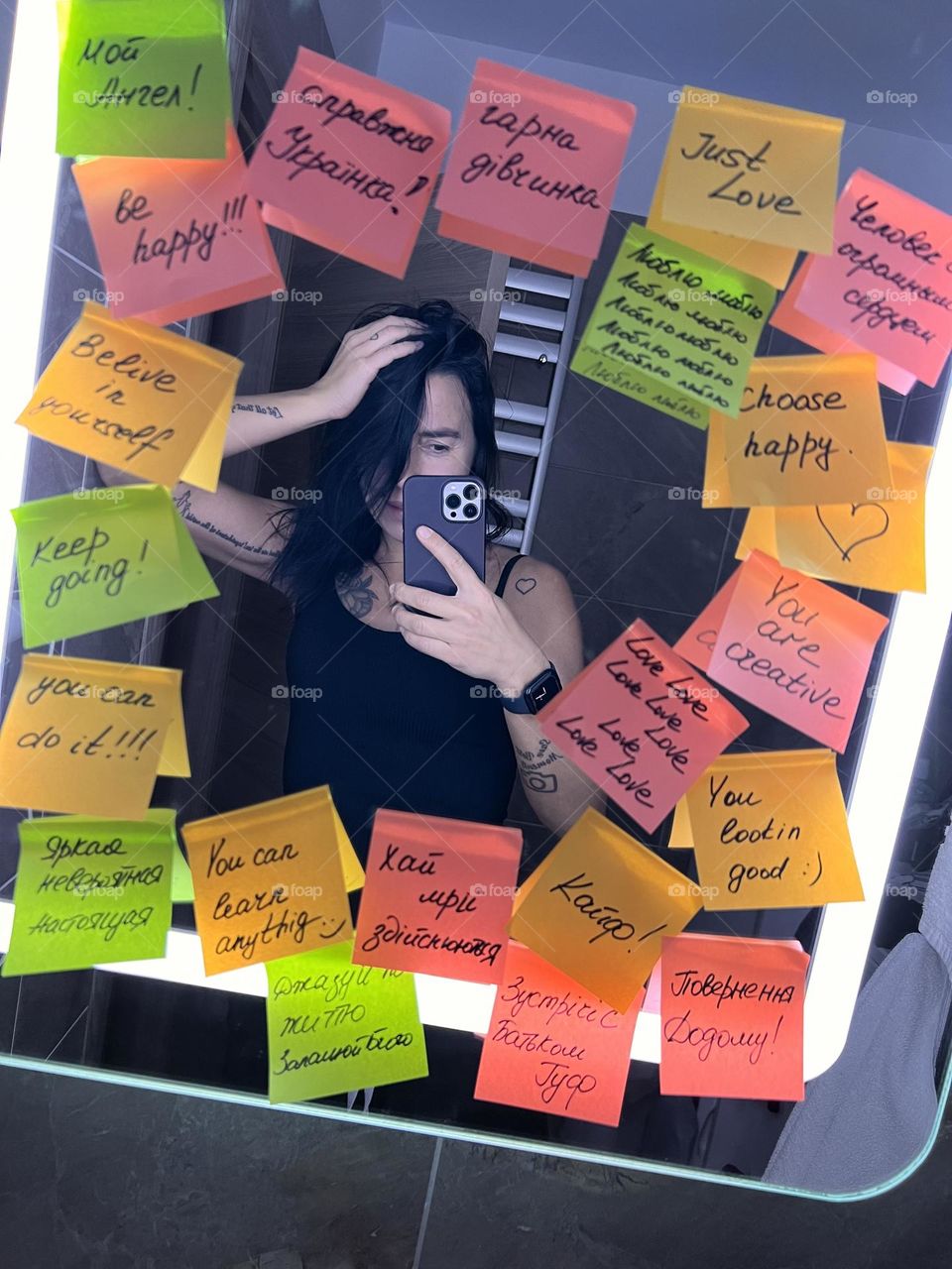 pasted over the mirror with supporting stickers, the girl takes a selfie in the mirror