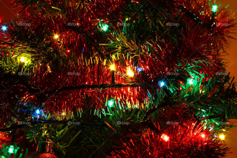 Macro shot of Christmas tree decorations and vivid lights