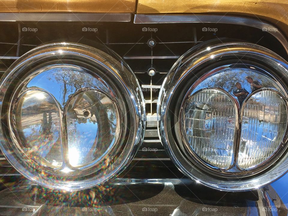 1961 cats eyes headlamps on gold Cadillac deVille 