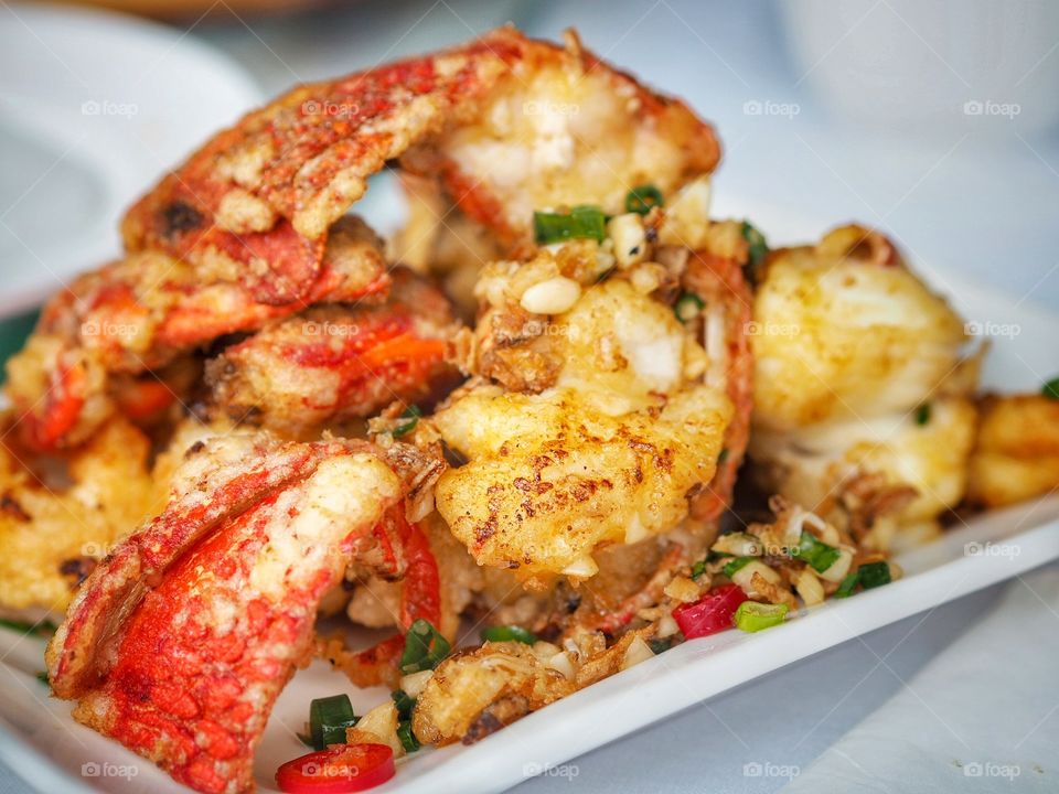 Fried lobster, presented on a plate in small pieces. A popular food item in a yum cha or dim sum line up.