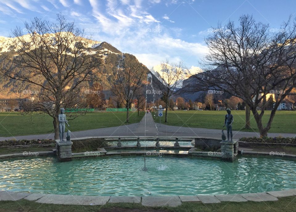 Public fountain amidst a picturesque landscape 