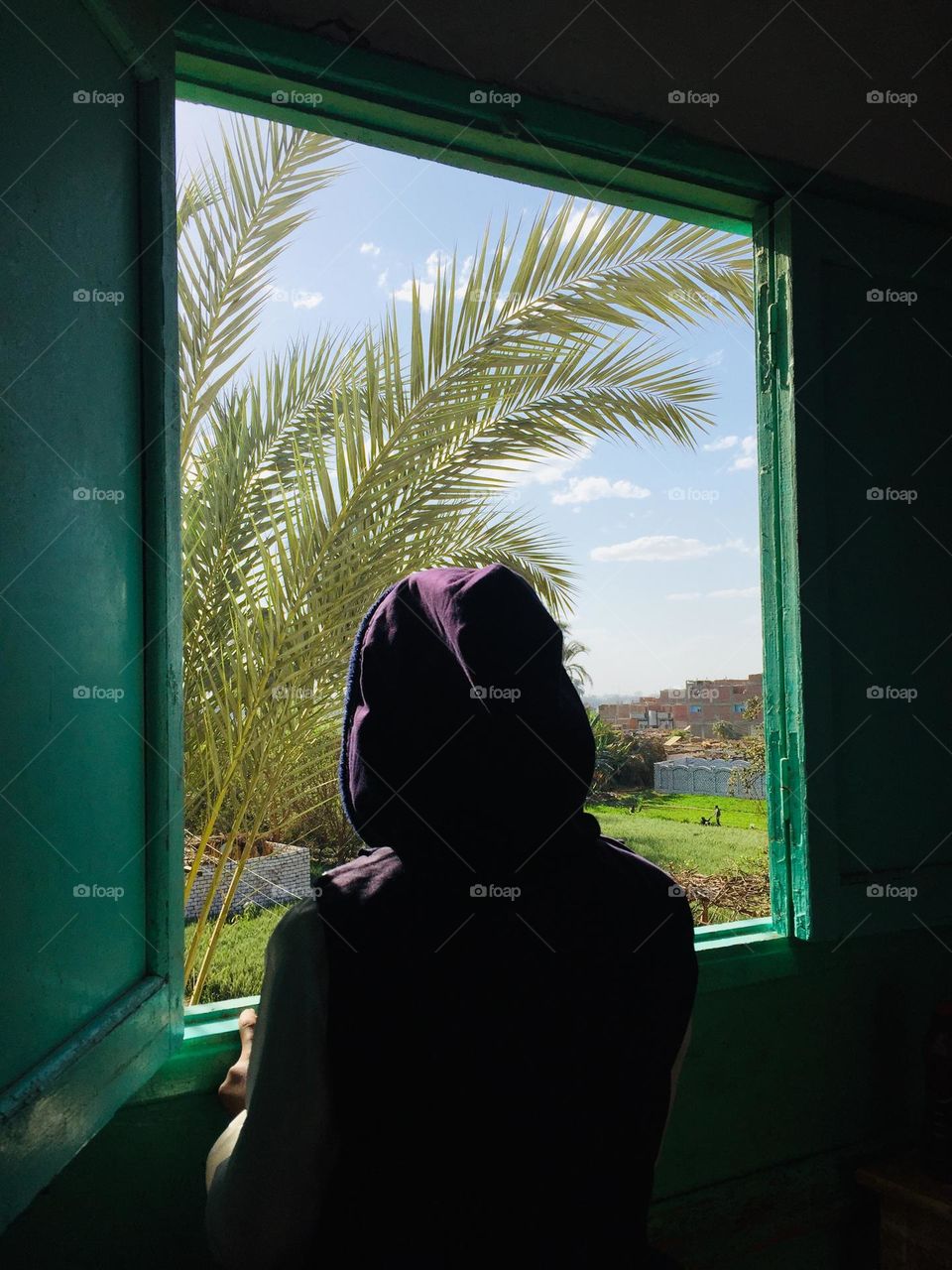 A girl is looking from a window