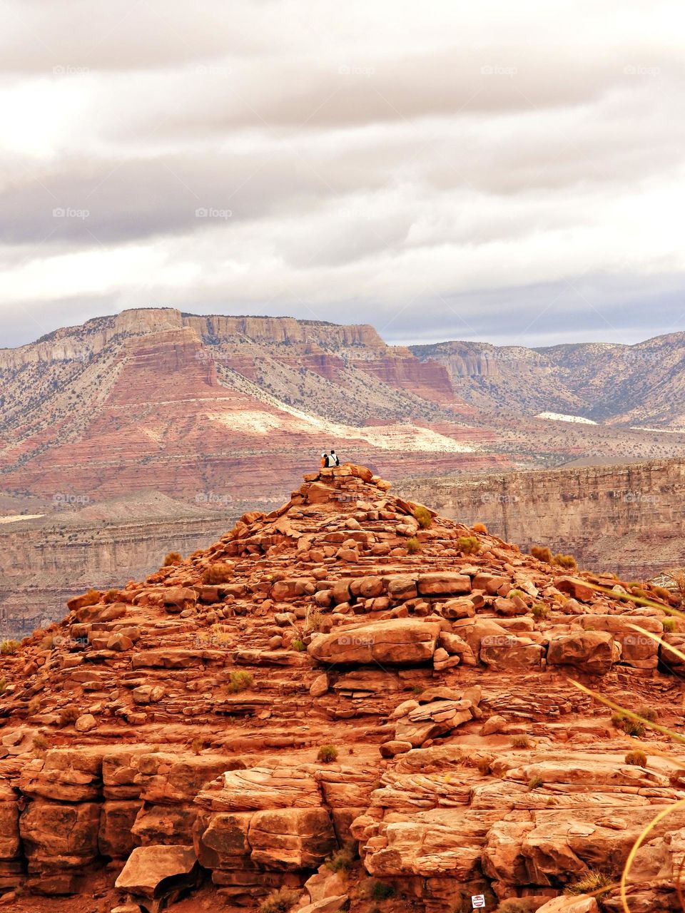 After reaching the top of the summit the hikers sit on top of the rocks and marvel over the breathtaking textures and intense colors of the surrounding landscape