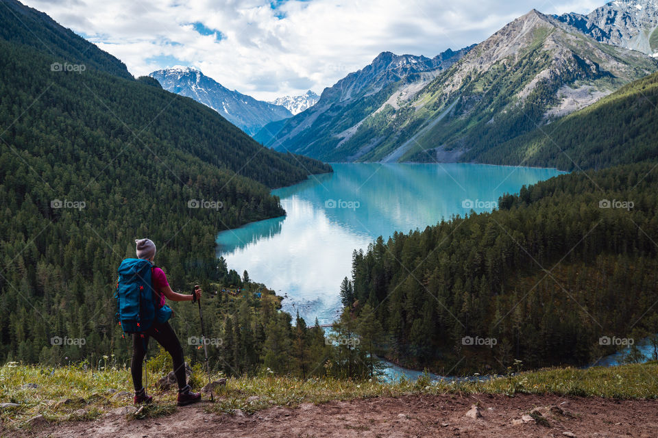 Hiking in Altai mountains. Western Siberia. A woman with a big backpack. Trekking