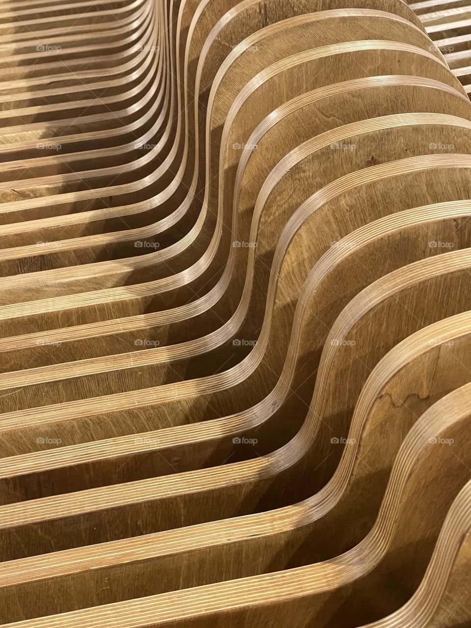 Curved wooden section of a modern bench 