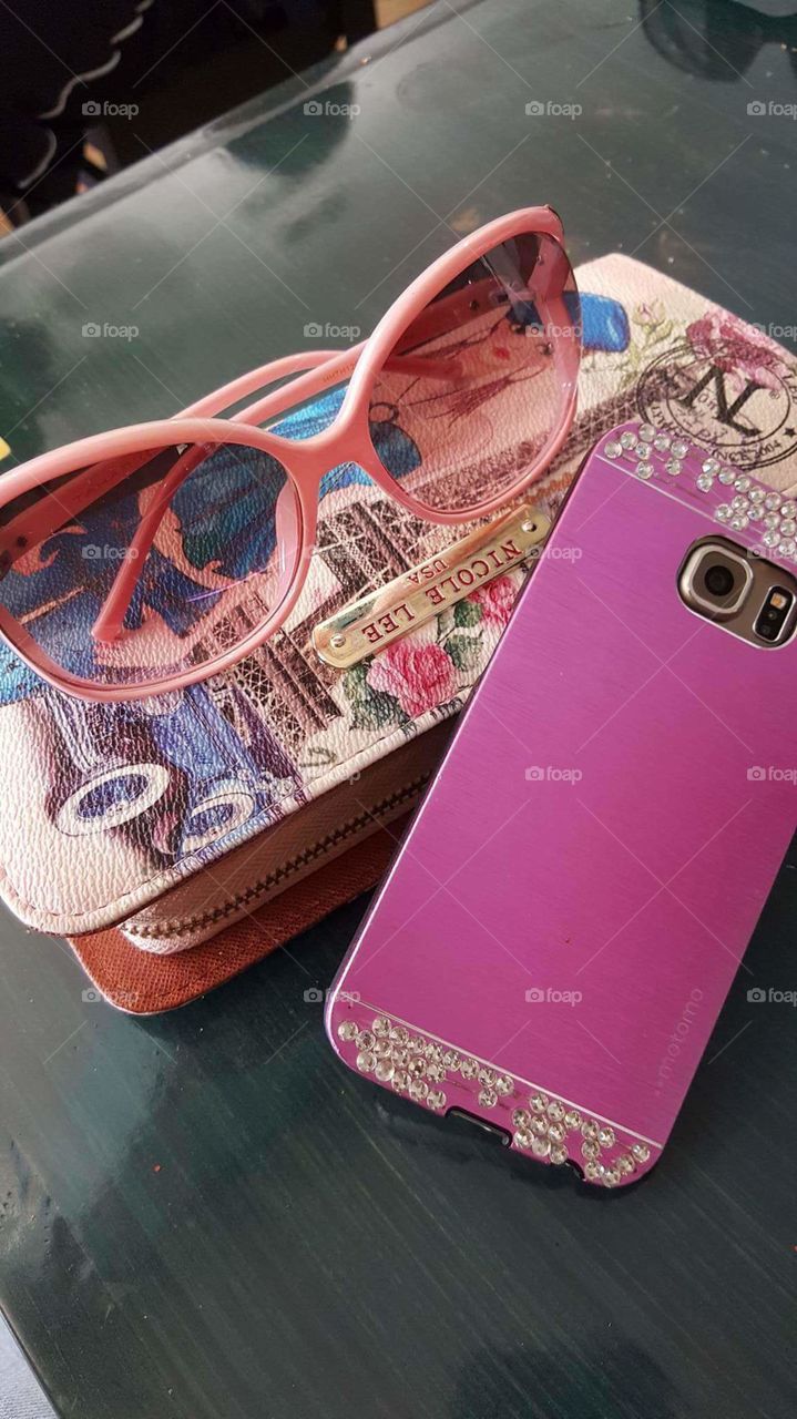 pink glasses, purse and phone