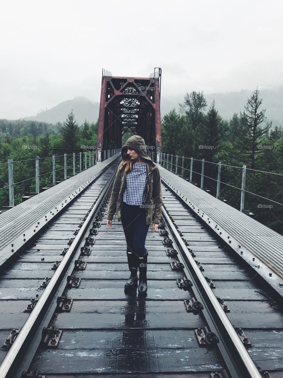 Woman posing at abandoned railroad bridge