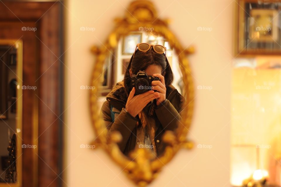 Girl with the camera in the mirror