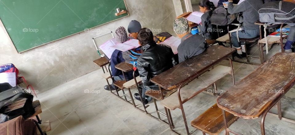 student sit down in his class room