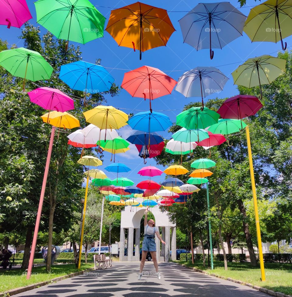 A colorful alley with umbrellas