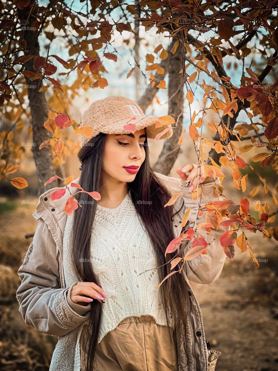 Portrait of a young girl among autumn leaves