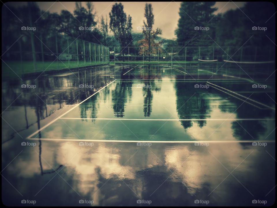 Reflection After Rain. Rain soaked Tennis Court Reflection