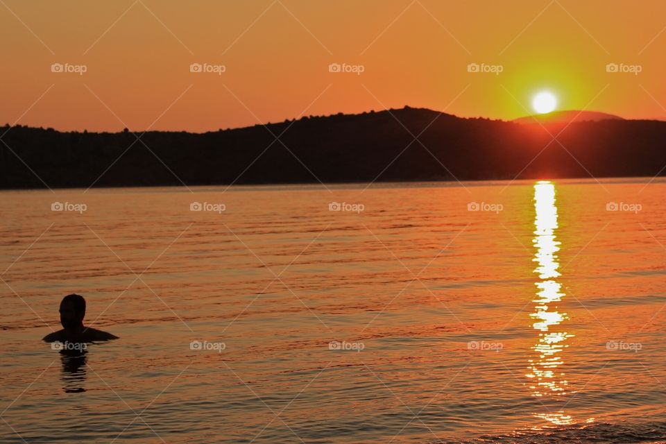 Swimming during sunset