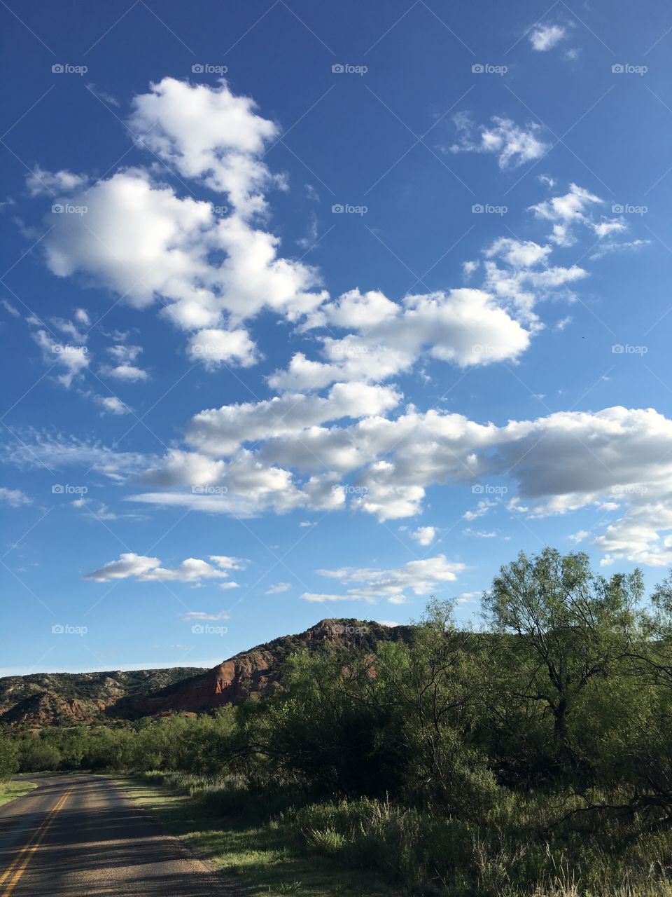 “The passage of time” these clouds contrast to the blue sky behind them symbolize the stark beauty of life while reminding us all how fleeting it really is. Taken in Palo Duro canyon 